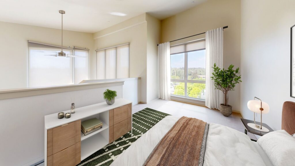 Bright, modern bedroom with large windows, sheer curtains, a potted plant, a bed with white linens and a brown throw, a green patterned rug, and a wooden sideboard with decor items. Sunlight fills the minimalist space.